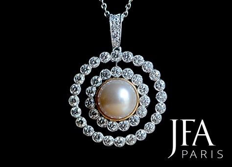 Pendentif en platine et or jaune serti en son centre d´une perle et d´un double entourage de diamants articulés.